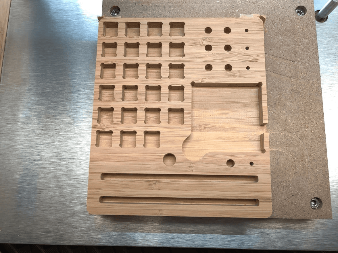CNC-machined bamboo component reference case with rounded pockets, round holes and long slots