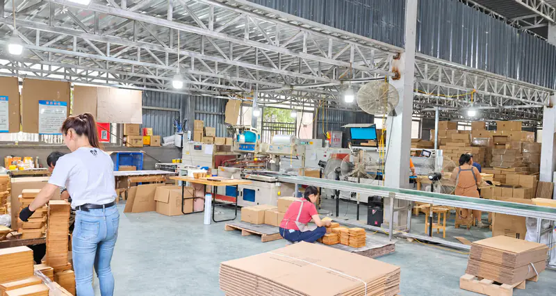 Cutting-board workshop with staff, work tables and packing materials